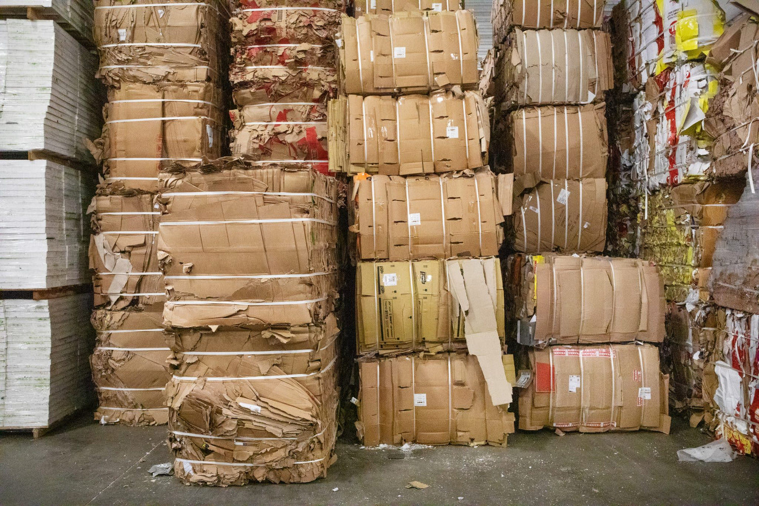 Bails of recycled cardboard, symbolizing teeone's dedication to using recycled packaging materials in our operations.