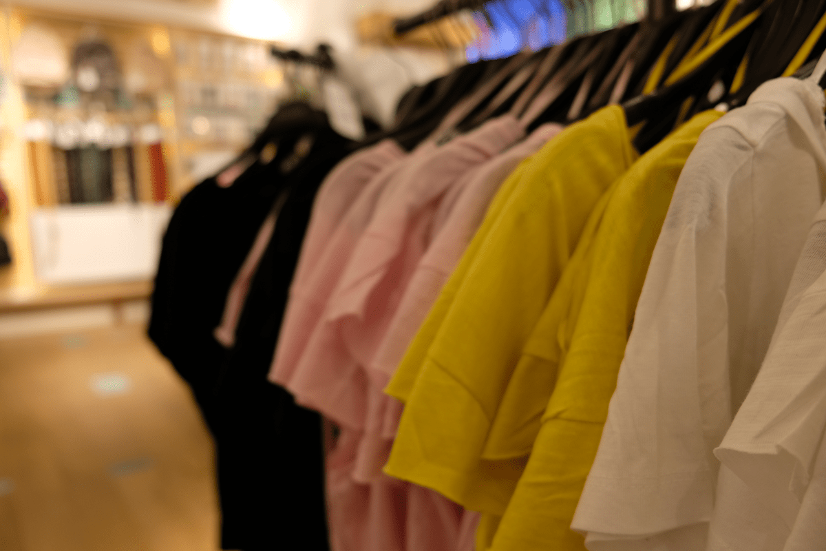 Close-up of premium printed garments on a garment rail in a clothing store