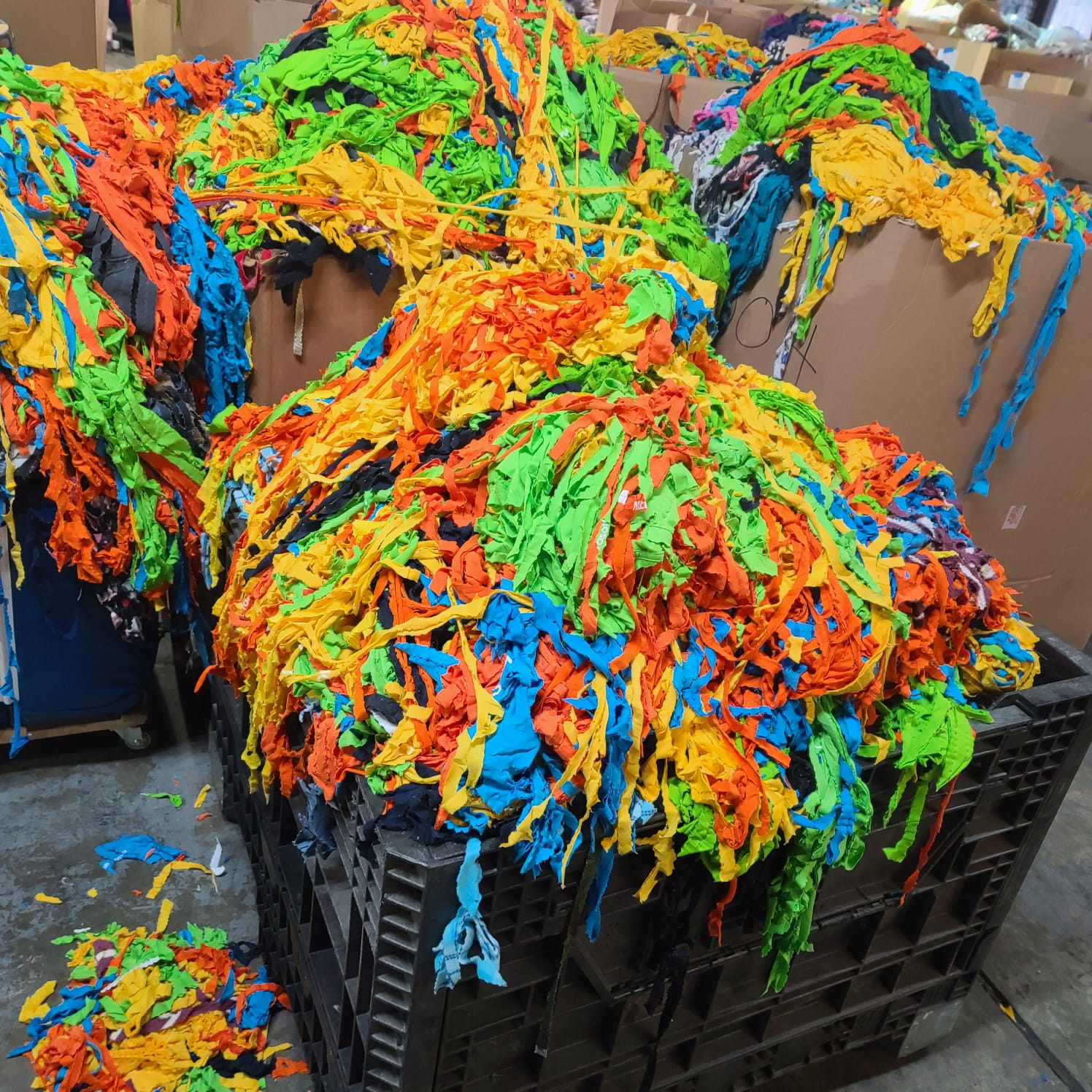 Photograph depicting the initial stage of fabric destruction as part of the recycling process at teeone, underscoring our commitment to sustainability