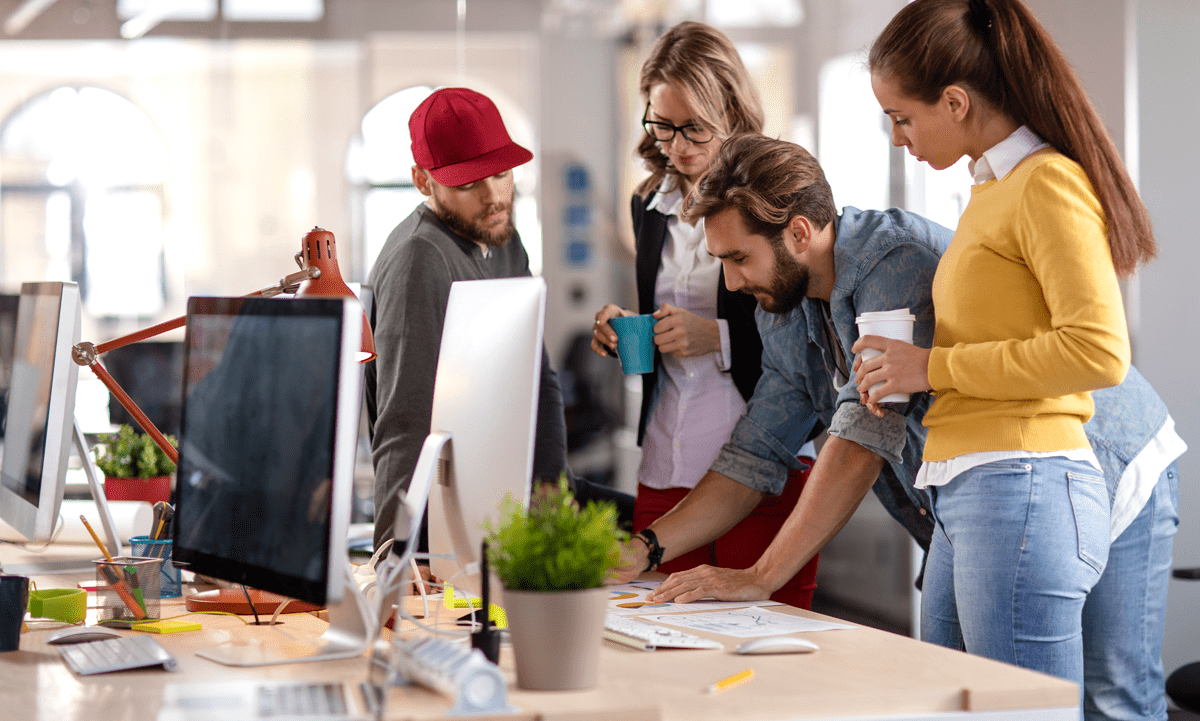 Group of young professionals in a marketing agency or design studio engaged in a discussion about the comprehensive and efficient services provided by teeone.